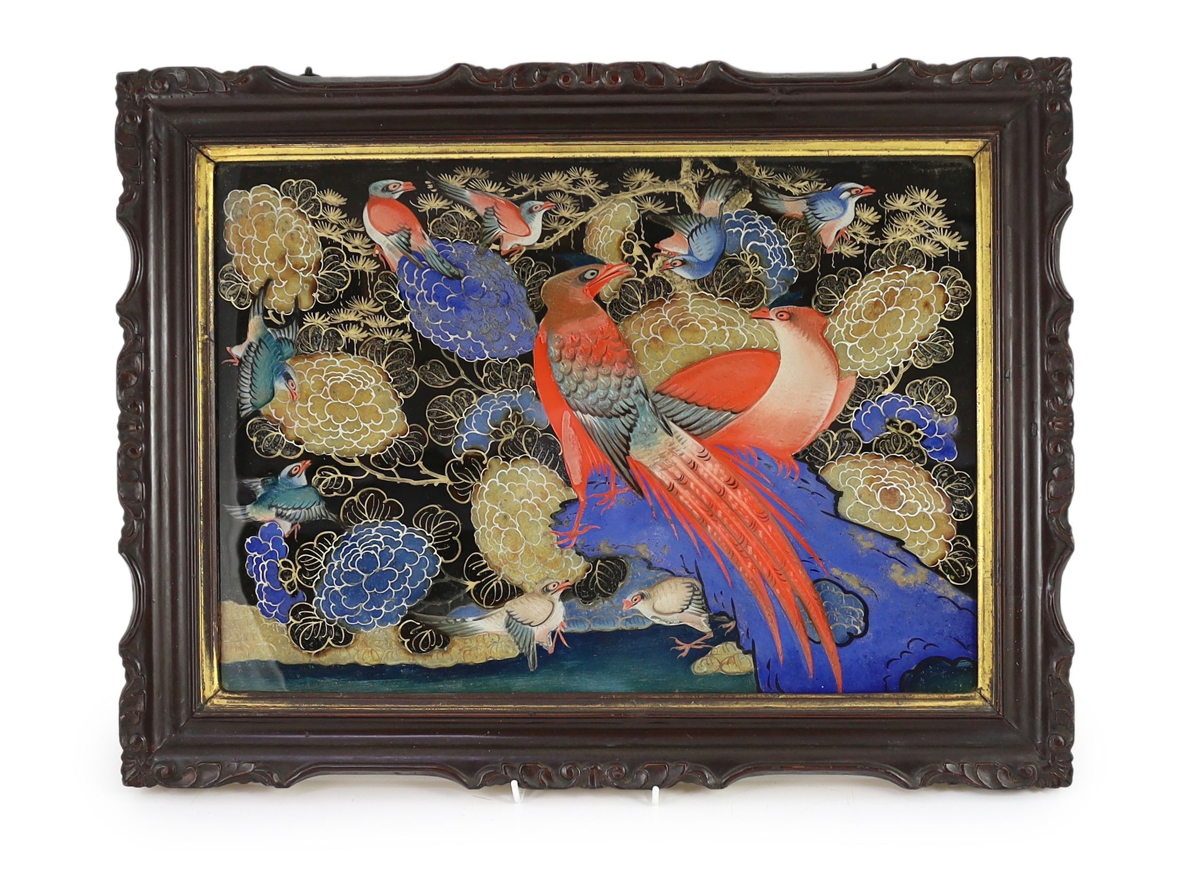 An unusual Korean reverse painted glass picture, 19th century, decorated with colourful birds amid flowers on a black ground, in original lacquered wood frame, 35 x 50cm